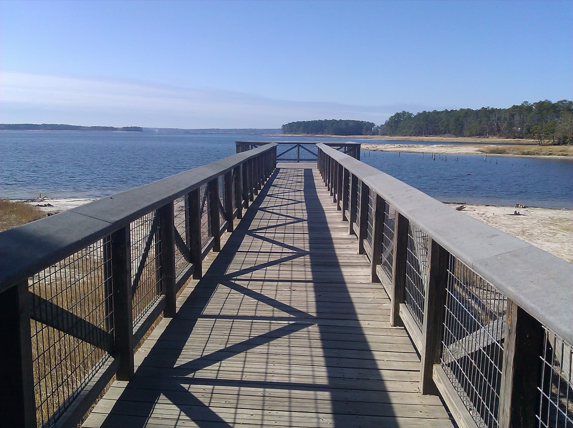 A wooden fishing pier reaching into the open water at South Toledo Bend State Park, Louisiana